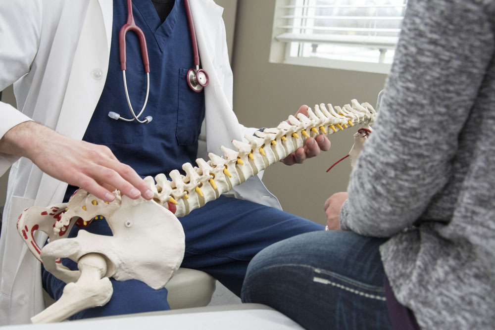 chiropractor and patient discussing herniated disc